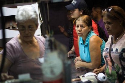 Compras en un mercado de abastos en Caracas.-EFE / CRISTIAN HERNANDEZ