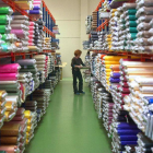 Una mujer coloca una tela en una fábrica de tejidos.-ISRAEL L. MURILLO