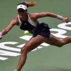 La tenista española Garbiñe Muguruza, durante el partido ante Petra Kvitova, disputado en Singapur.-AFP / MOHD FYROL