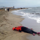 Un miembro de los equipos de rescate contempla el cuerpo de un inmigrante sobre la playa en Ayvalink (Turquía).-AP