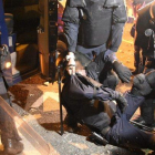 Un policía, cargado por sus compañeros tras ser herido en los enfrentamientos con los manifestantes en Via Laietana, este viernes.-MANU MITRU