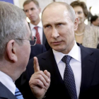 El presidente ruso, Vladímir Putin, habla con su homólogo del COI, Thomas Bach, durante los Juegos de Sochi.-AP / DAVID GOLDMAN
