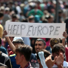 Un inmigrante se manifiesta este jueves en Budapest con una pancarta en la que se lee "Ayúdanos Europa".-AFP / FERENC ISZA