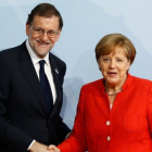 El presidente Mariano Rajoy junto a la canciller Angela Merkel.-AFP/ODD ANDERSEN