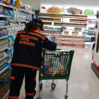 Una agente de Protección Civil realiza la compra en el supermercado.