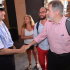 El nuevo alcalde de Génova, el conservador Marco Bucci (centro), saluda a un policía local a su llegada al Palazzo Tursi, sede de la alcaldía de Génova, el 26 de junio.-