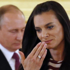 Isinbayeva, delante de Putin, en el acto de despedida del equipo olímpico.-EFE / YURY KOCHETKOV