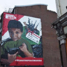 Un mural que muestra a un nino yemeni con una pistola.-EFE FACUNDO ARRIZABALAGA / EPA