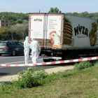Unos forenses inspeccionan el camión donde fueron hallados los cadáveres.-Foto:   EFE / ROLAND SCHELAGER