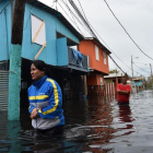 Dos personas caminan por una calle inundada en Juana Matos (Puerto Rico), el 21 de septiembre-AFP / HECTOR RETAMAL