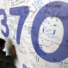 Fotografía de archivo del 13 de marzo del 2014 de un hombre escribiendo mensajes en recuerdo a las víctimas del vuelo MH370 de Malaysia Airlines en el aeropuerto internacional de Kuala Lumpur (Malasia).-EFE