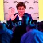 Puigdemont saluda desde la gran pantalla del acto fundacional de la Crida que se ha celebrado este sábado en el pabellón Nou Congost de Manresa.-AFP