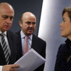 Jorge Fernández Díaz, Luis de Guindos y Soraya Saenz de Santamaría en una foto de archivo.-