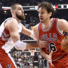 Pau Gasol trata de avanzar con el balón ante la férrea defensa de Jonas Valanciunas, en el partido entre los Bulls y los Raptors.-Foto: AP / FRANK GUNN