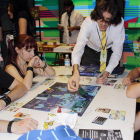 Cuatro jóvenes participan en uno de los torneos de las Jornadas de Manga y Ocio Alternativo que se celebra en el Hangar.-ECB