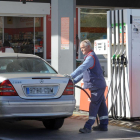Un operario echa gasolina en un coche.-ISRAEL L. MURILLO