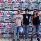 Tres de los organizadores del festival posan sonrientes tras una de sus tradicionales pegadas de carteles en Villarcayo.-DOLMEN MUSIC FEST