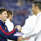 Messi y Cristiano se saludan en la previa del Barcelona-Real Madrid del pasado mes de abril.-ALBERT GEA / REUTERS