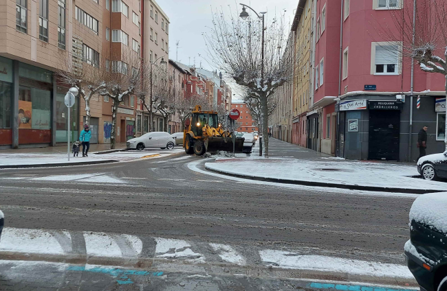 Una excavadora limpia de nieve la calzada en la calle Briviesca de Burgos. L. G. L.