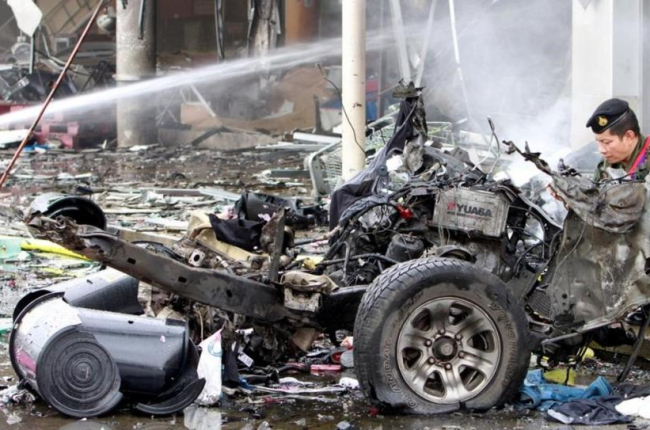 Restos de un coche destruido por las bombas que han estallado en el centro comercial.-REUTERS / SURAPAN BOONTHANOM