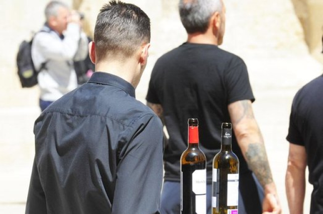 Un camarero sirve una copa de vino en un terraza. ECB