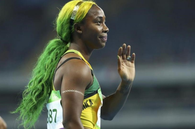 Fraser-Pryce, con los colores de la bandera jamaicana en el pelo.-REUTERS / LUCY NICHOLSON