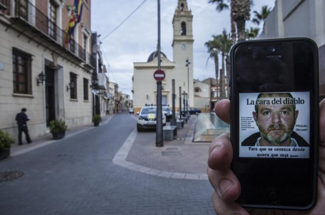 Imagen en un smartphone de Miguel Ricart, el asesino de las niñas de Alcàsser, en la plaza del ayuntamiento de la localidad valenciana.-/ MIGUEL LORENZO