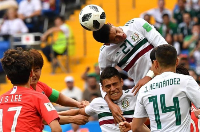 dson Álvarez cabecea entre varios jugadores de México y Corea del Sur.-AFP / JOE KLAMAR