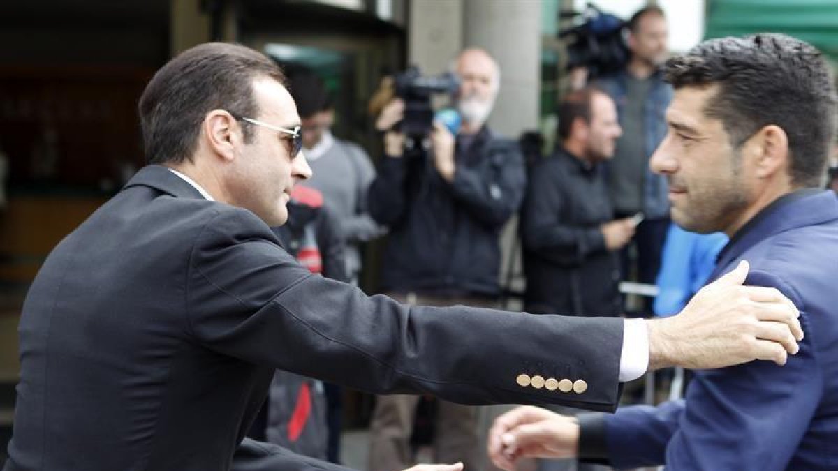 Los toreros Enrique Ponce (i) y Manuel Caballero se saludan a las puertas del tanatorio La Paz de Alcobendas.-EFE