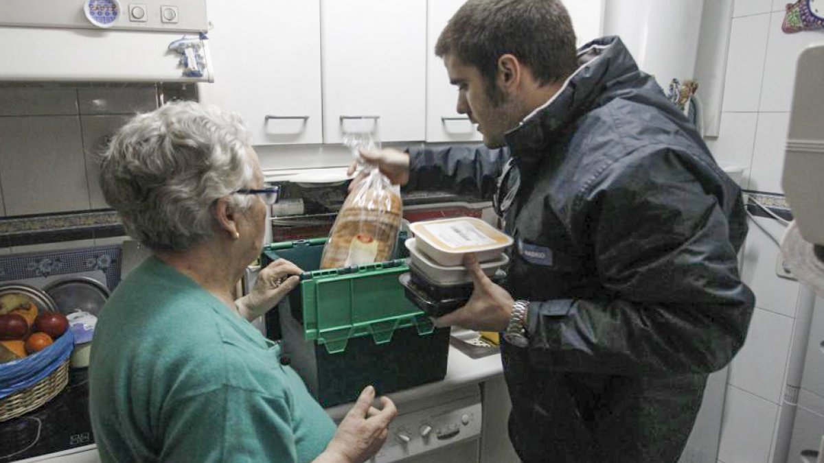 Una mujer recibe el catering a domicilio como se ve en esta imagen de archivo. Sergio Gonzalez.