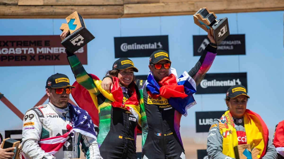 La piloto burgalesa junto a Loeb, pertrechados con las banderas nacionales, celebran el título. ECB