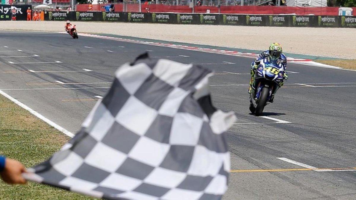 Valentino Rossi cruza primero la línea de meta de Montmeló, por delante de Marc Márquez.-AP