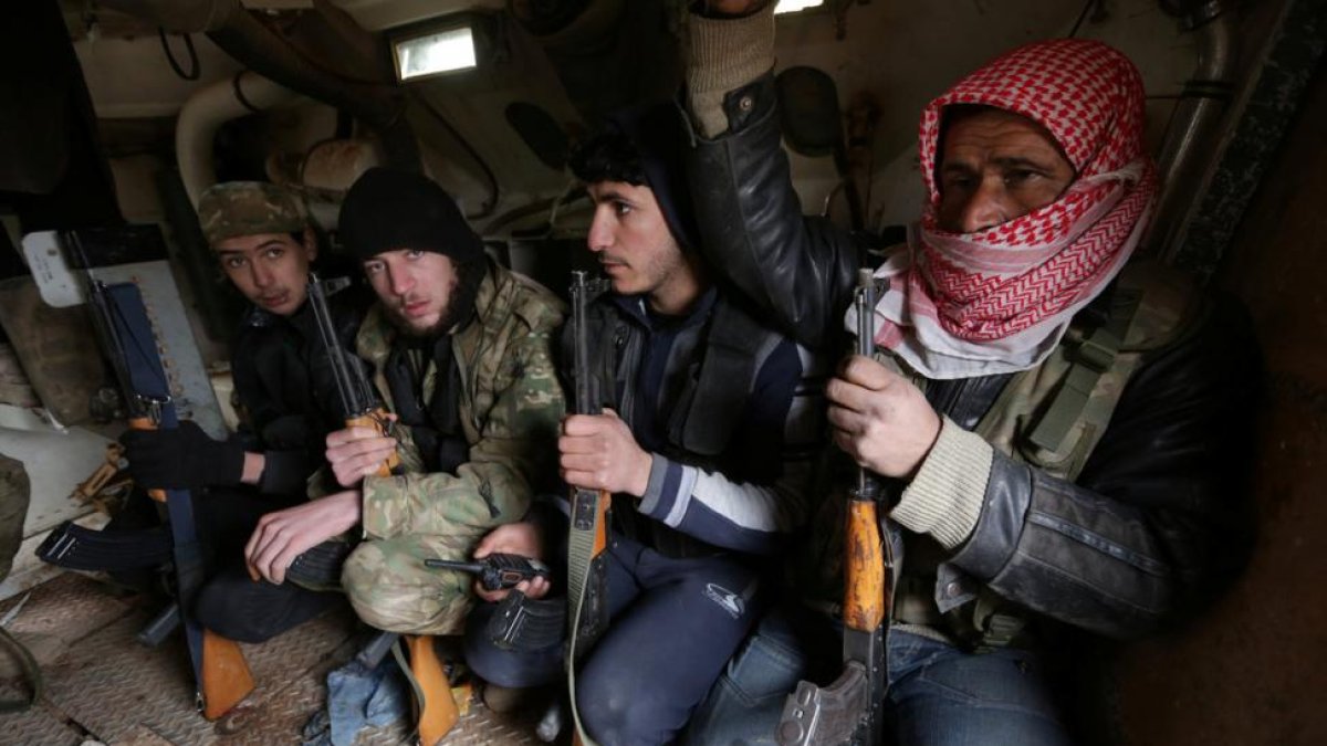 Rebel fighters ride a military vehicle, as they advance towards the northern Syrian town of al-Bab, Syria January 15, 2017.-KHALIL ASHAWI / REUTERS
