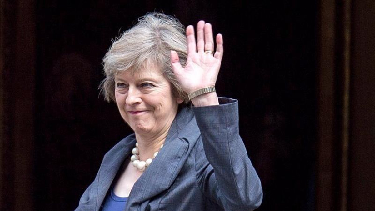 La ministra del Interior británica, Theresa May, saluda a los medios a su llegada a Downing Street para asistir al último consejo de ministros con David Cameron como anfitrión en Westminster, en el centro de Londres.-EFE / Will Oliver