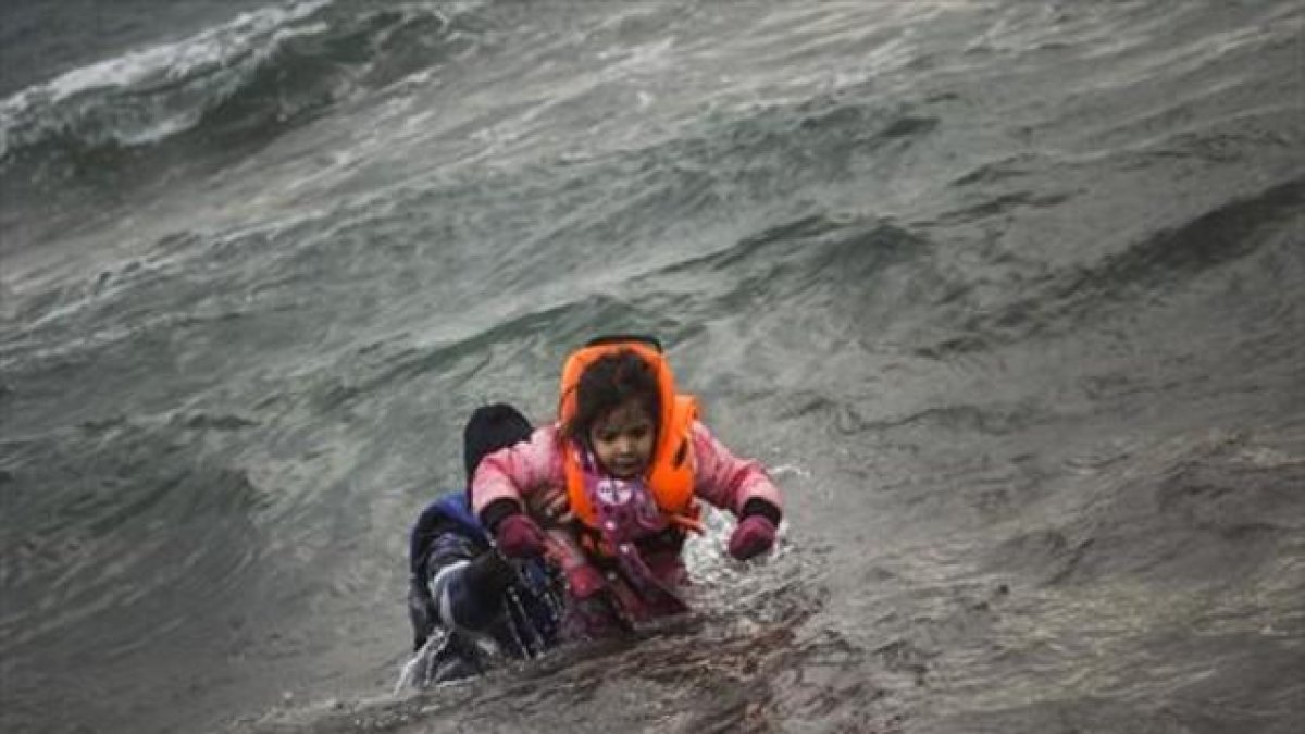 Refugiados tratando de llegar a Lesbos.-AP / SANTI PALACIOS