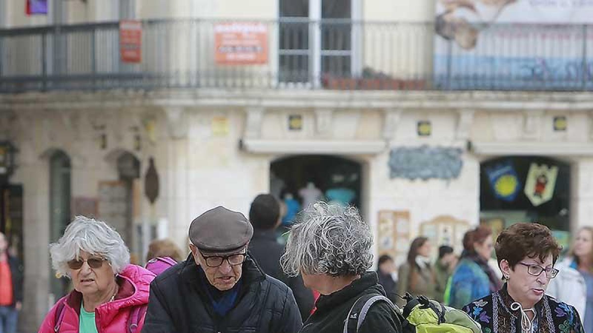 Dos turistas dialogan con un hombre frente a la Catedral de Burgos.-RAÚL G. OCHOA