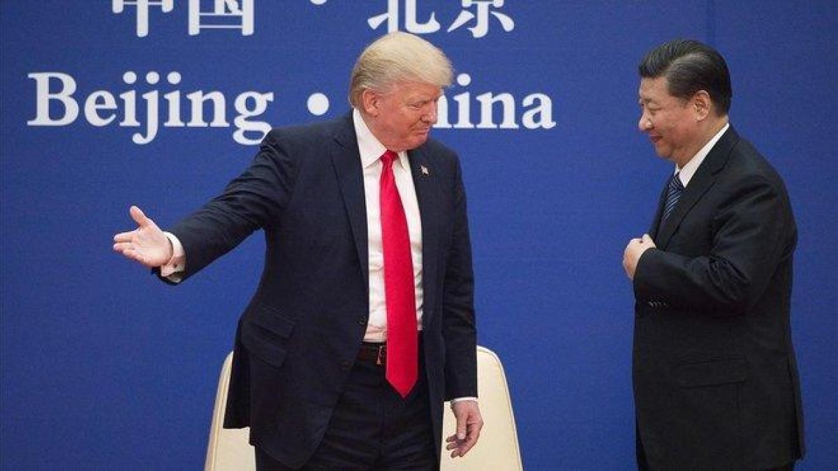Trump y Xi en noviembre del 2017 en Pekín.-AFP / NICOLAS ASFOURI
