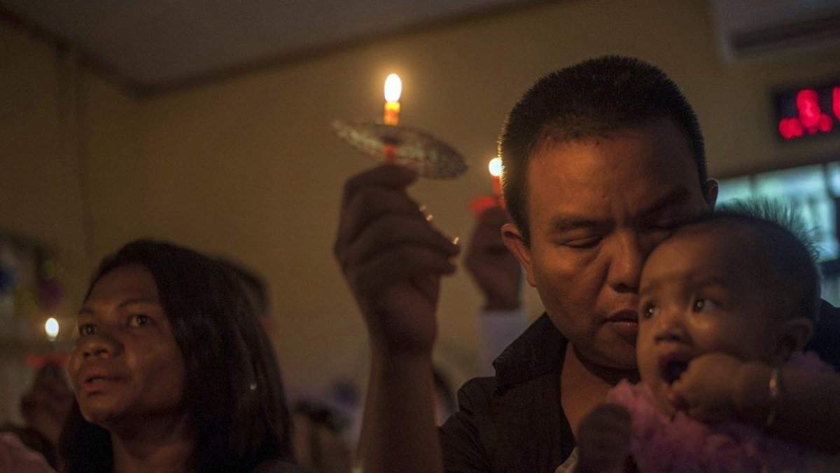 People attend a Christmas service at Rahmat Pentecostal Church in Carita Indonesia Christmas celebrations traditionally filled with laughter and uplifting music were replaced by somber prayers for tsunami victims in Indonesia-Fauzy Chaniago / AP