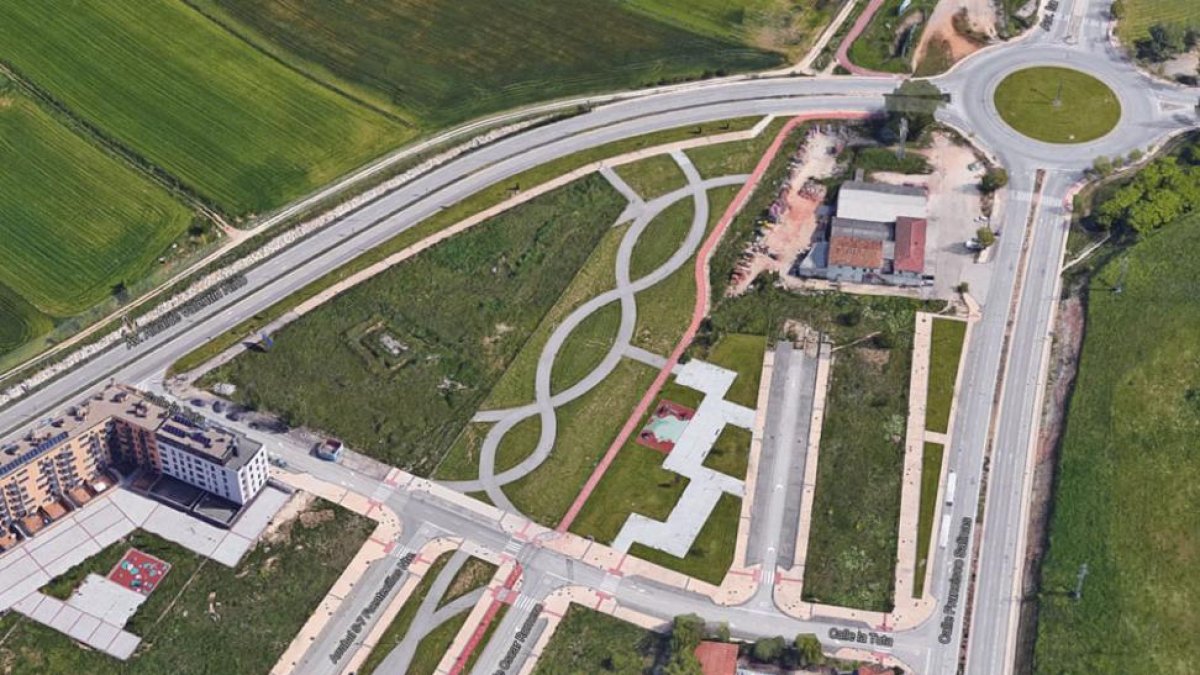 En esta imagen aérea se puede observar que las obras se pararon a mitad de un vial y junto a la glorieta los almacenes de materiales de construcción.-ECB