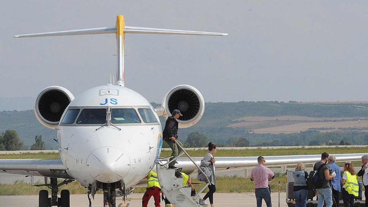 Varios pasajeros en la pista del aeropuerto de Villafría.-ISRAEL L. MURILLO