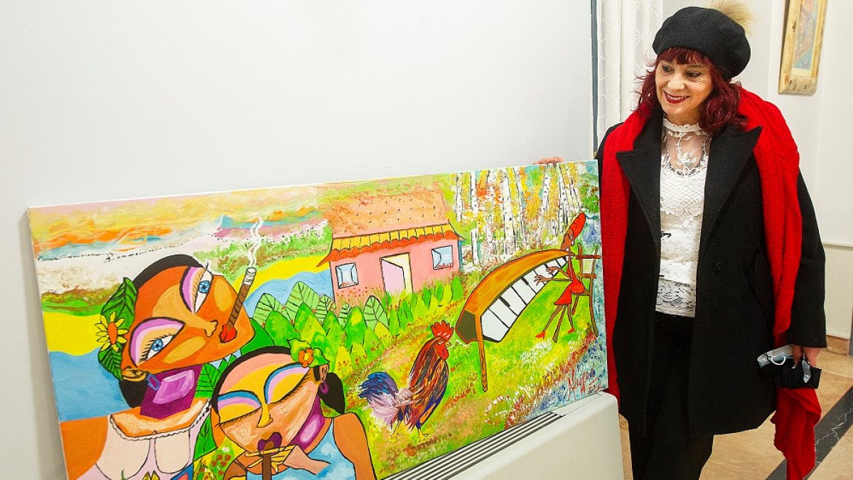 Mayfeé Hernández posa junto a una de sus obras en la sala de exposiciones del Teatro Principal de Burgos. ISRAEL L. MURILLO