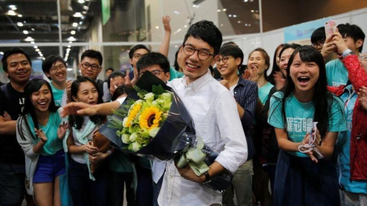 Nathan Law, uno de los líderes de la 'revolución de los paraguas' en el 2014, celebra con sus seguidores el escaño ganado en las elecciones legislativas de Hong Kong.-REUTERS / TYRONE SIU