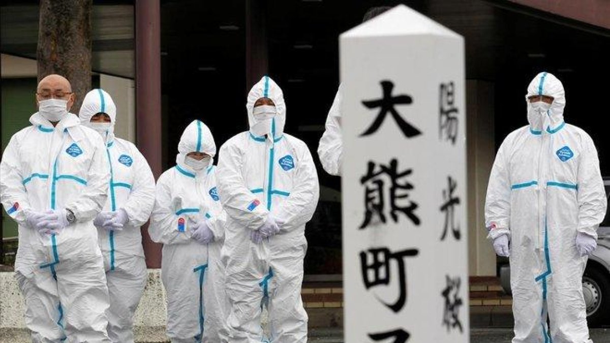 Los evacuados de la ciudad de Okuma, afectada por el terremoto de Fukushima, rinden homenaje a las víctimas.-KIM KYUNG-HOON/EFE