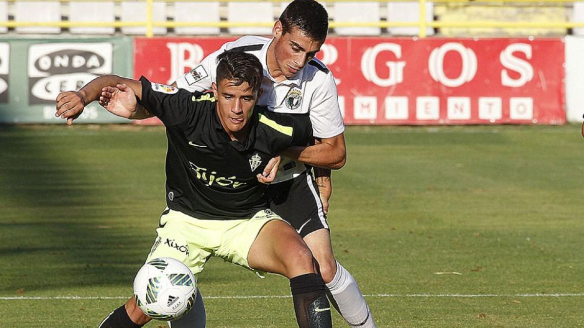 Sergio Esteban defiende a un jugador del Sporting B en un duelo en El Plantío-Santi Otero
