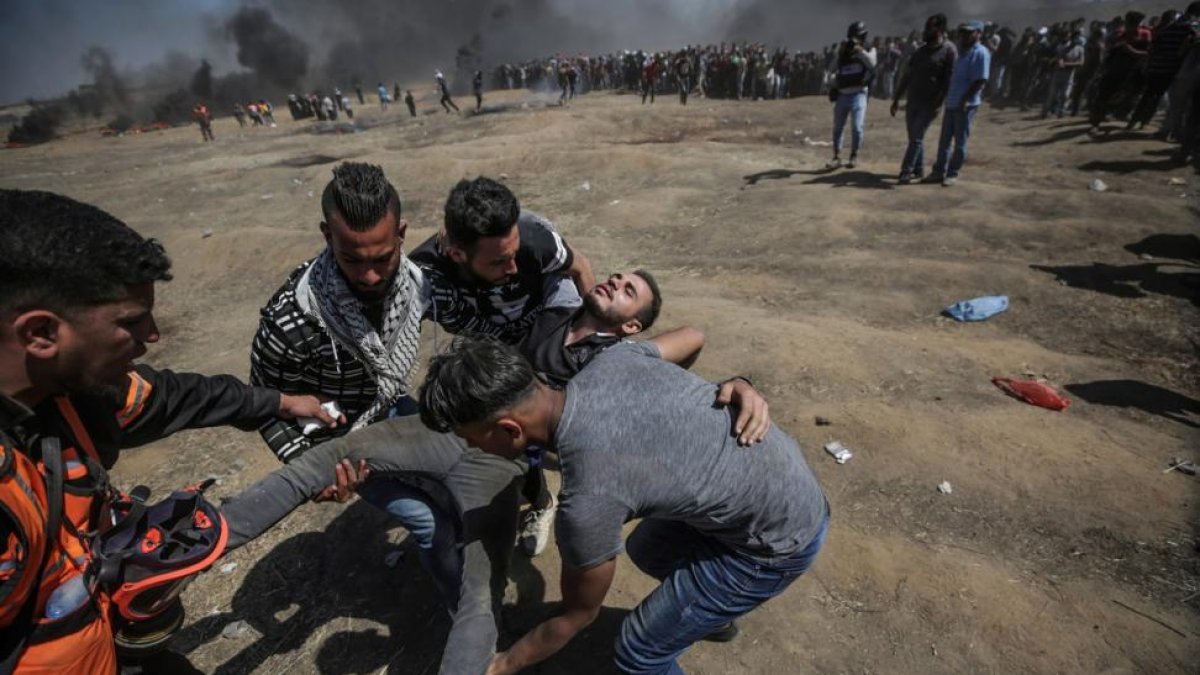 Manifestantes palestinos heridos cuando protestaban cerca de la frontera con Israel, el pasado lunes 14 de mayo, en el este de Gaza-/ MOHAMMED SABER (EFE)