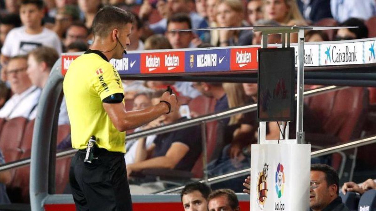 Gil Manzano chequea la jugada que condujo a la expulsión de Lenglet, en el Barça-Girona de Liga.-REUTERS / ALBERT GEA