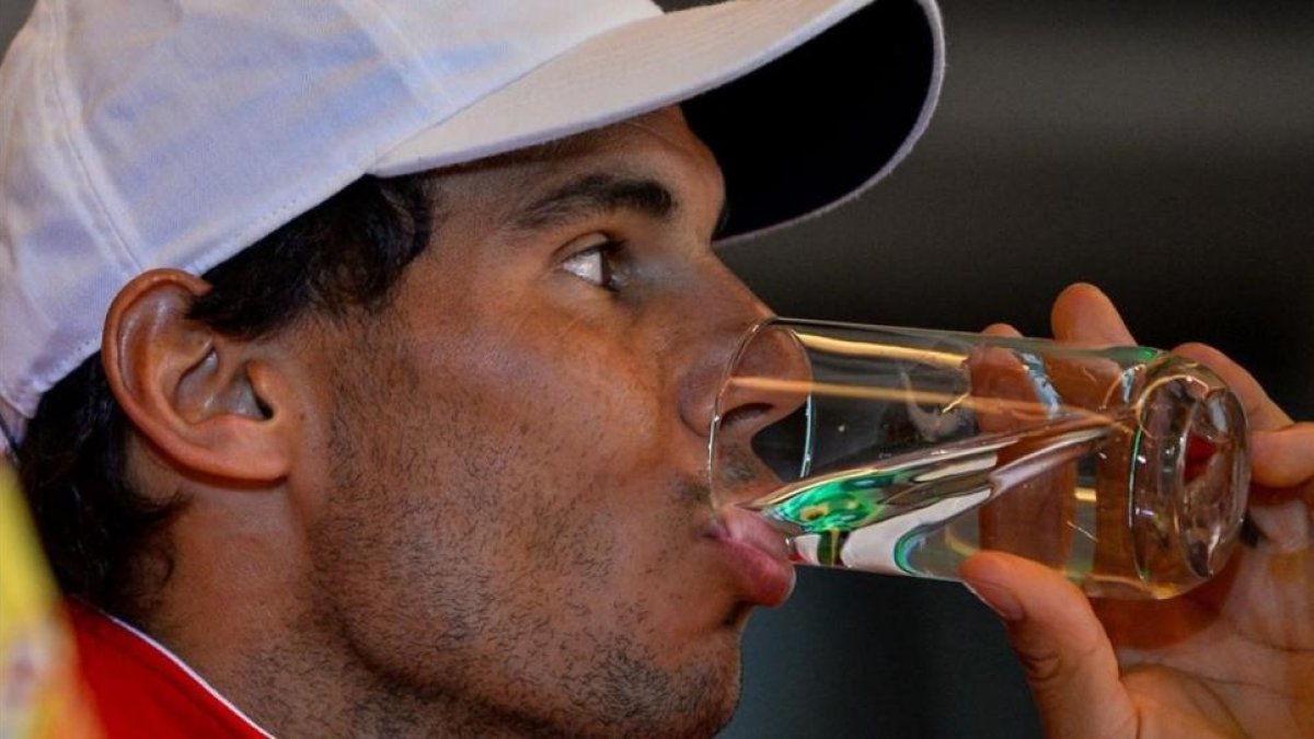 Rafael Nadal bebe agua durante el sorteo de la eliminatoria de Copa Davis contra la India.-AFP / CHANDAN KHANNA