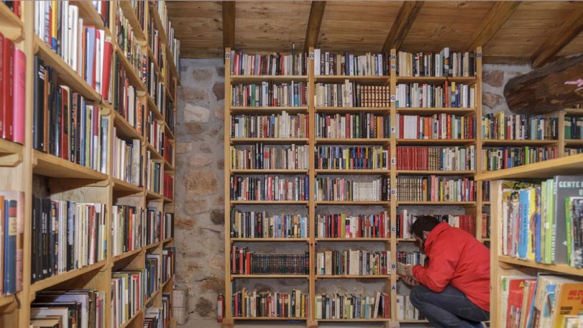 Las hileras de libros se extienden en la estanterías de la antigua pobrera y viejo potro del pueblo rehabilitado en el año 2006. -SANTI OTERO