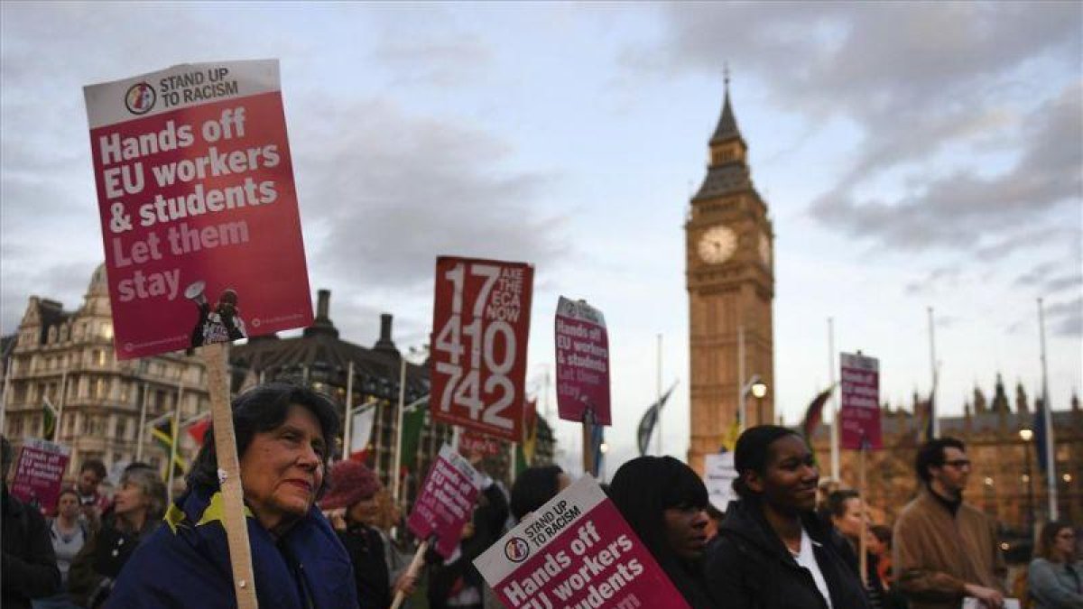 Varias personas manifiestan con pancartas delante del Parlamento en Londres, Reino Unido, el pasado lunes.-EFE