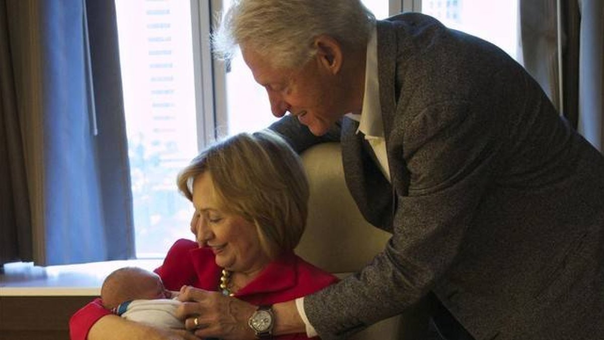 Hillary y Bill Clinton, con su nieto.-Foto: EL PERIÓDICO